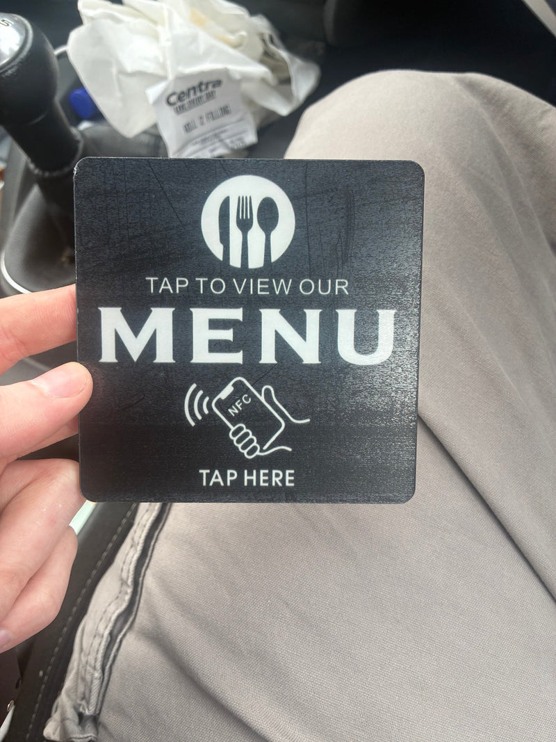 Actual black NFC menu card with white Tap to view our menu lettering